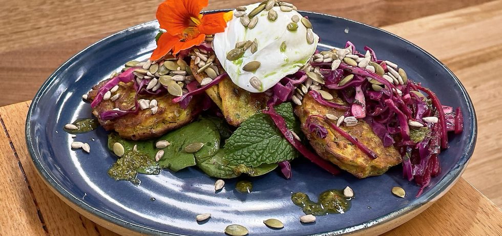 Corn fritters on a blue Robert Gordon Plate topped with Orange flower from Nancy Cafe Pakenham