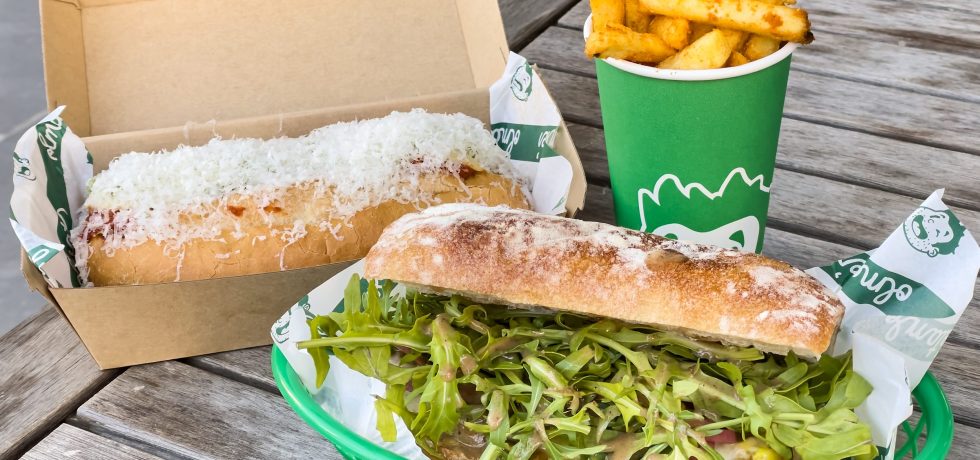 olmates sandwiches and chips on a wooden table