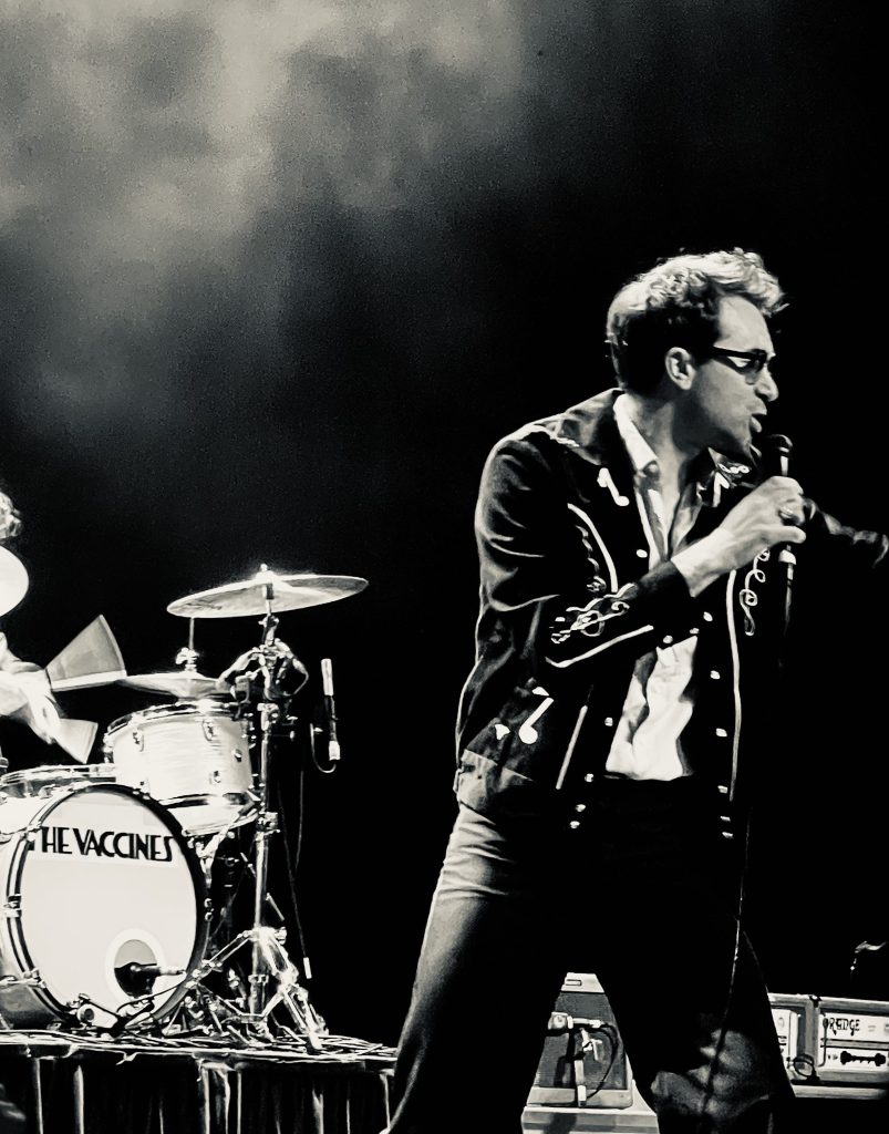 Black and white image of Justin from the vaccines singing and pointing at Forum Melbourne