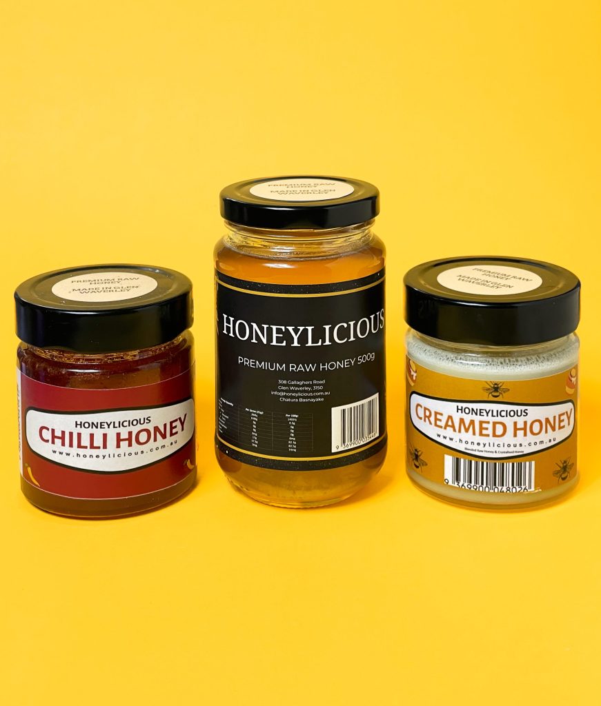 3 jars of Honeylicious honey on a yellow background