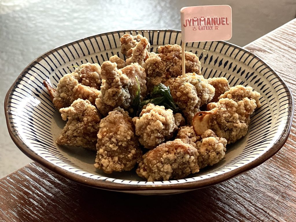Salt and Pepper chicken in black and white stripped bowl from Jymmanuel Eatery in Ripponlea