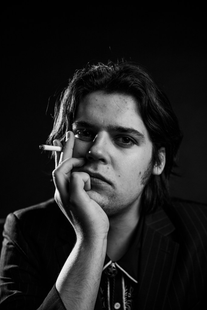 Evan Williams black and white close up portrait with a cigarette in his hand