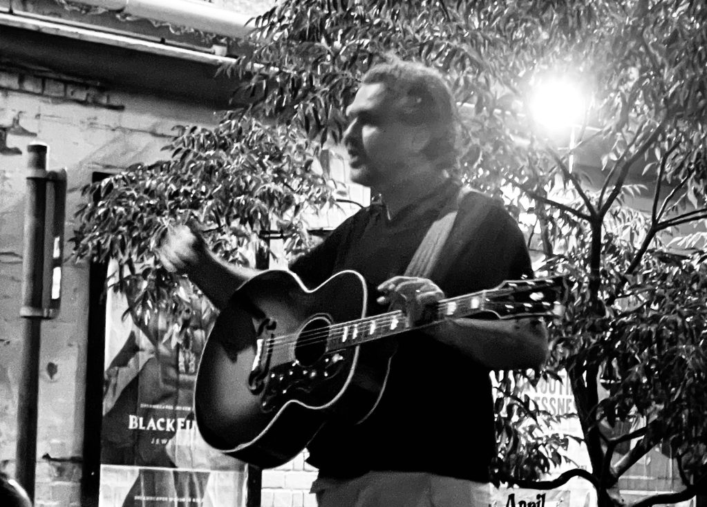 Jon McClure of Reverend and the Makers playing guitar outside the Curtin Hotel Melbourne