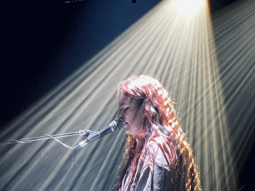 Mia Wray lit by a spotlight while playing piano at Melbourne's Corner Hotel
