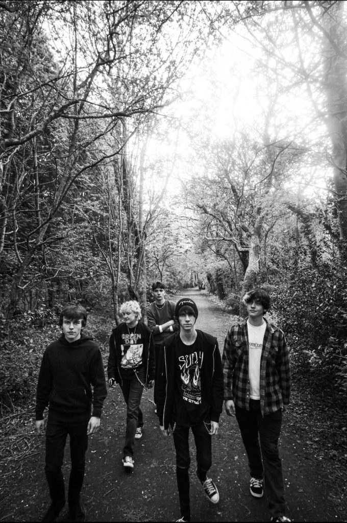 Newcastle band OCHISIA in black and white surrounded by trees.