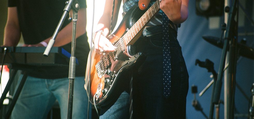 Close up image of woman playing guitar