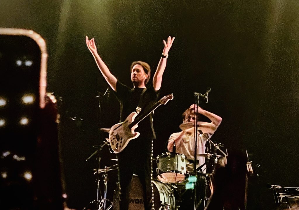 Matthew Murphy of the Wombats with his arms above his head at their gig at Festival Hall Melbourne September 2025