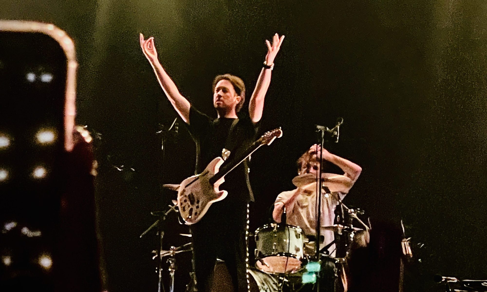 Matthew Murphy of the Wombats with his arms above his head at their gig at Festival Hall Melbourne September 2025