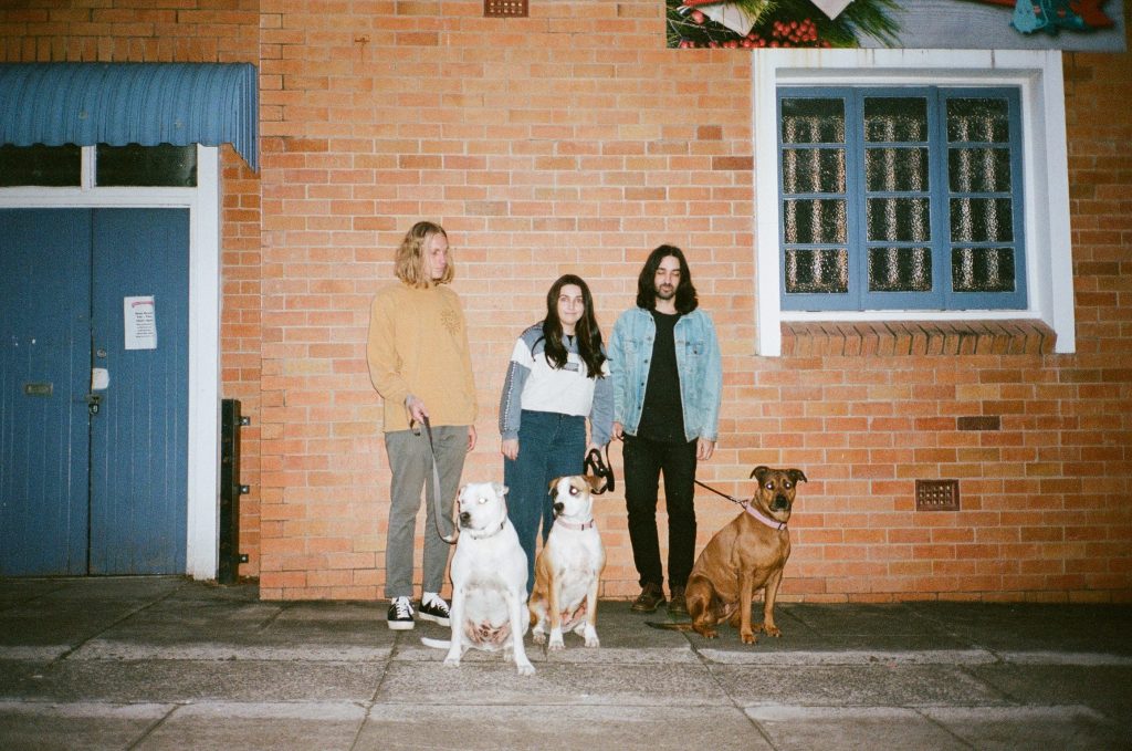 Band People Mover stood in front of a house for album Cane Trash