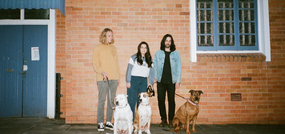Band People Mover stood in front of a house for album Cane Trash