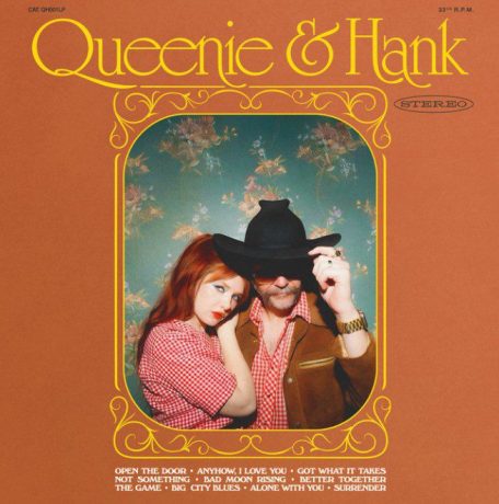 Album cover for Queenie and Hank. Image of queen hand henry wagons in red and white checked shirts surrounded by an orange border.