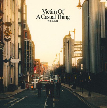 Cityscape taken from the middle of the road. People and buildings can be seen. Album Cover for The Clause Victim of a Casual Thing