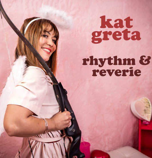 Image of Kat Greta with a bow, wearing a white outfit and white halo, against a pink background with the words Rhythm and Reverie