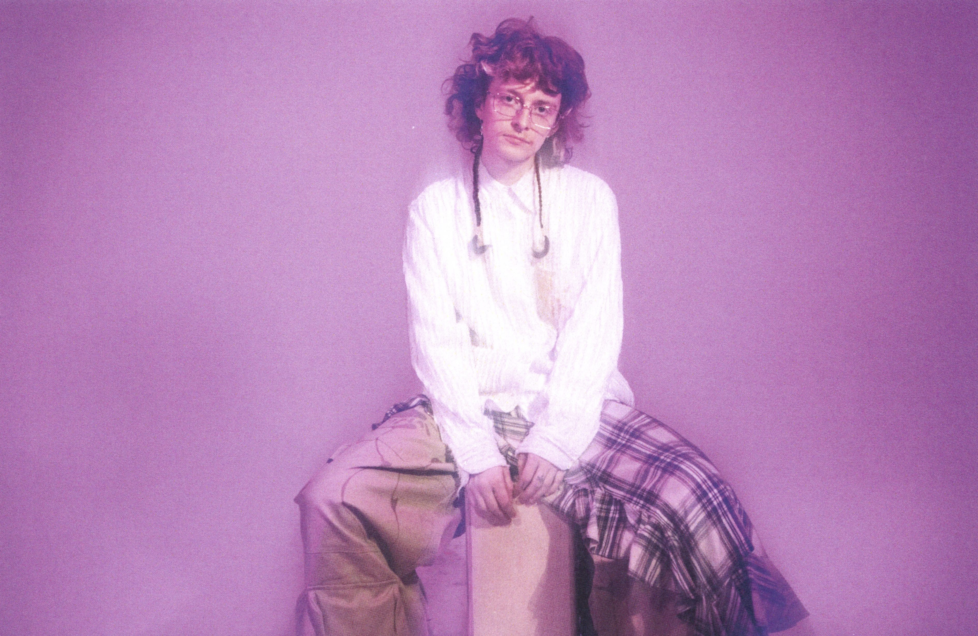 Image of singer Cavetown against a purple background