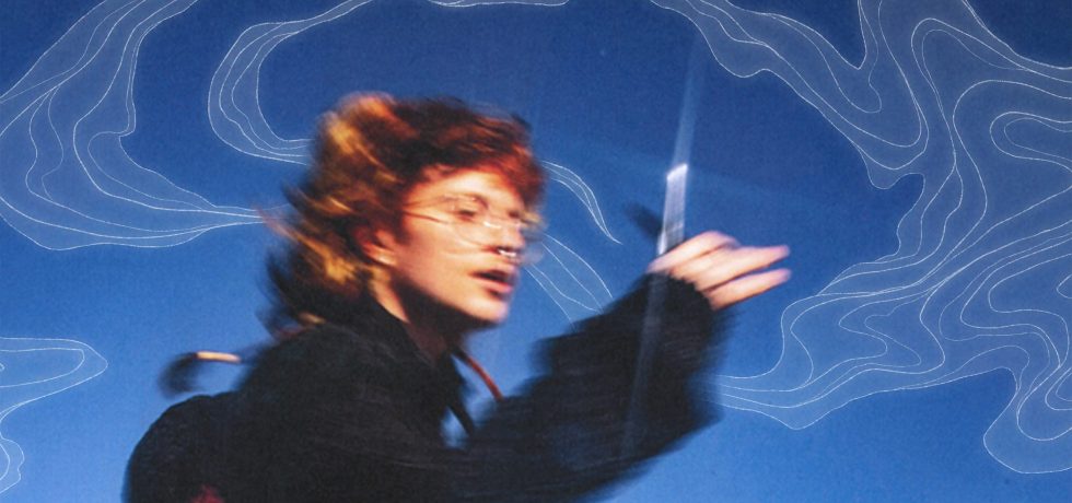 Musician Cavetown running with scissors against a blue background