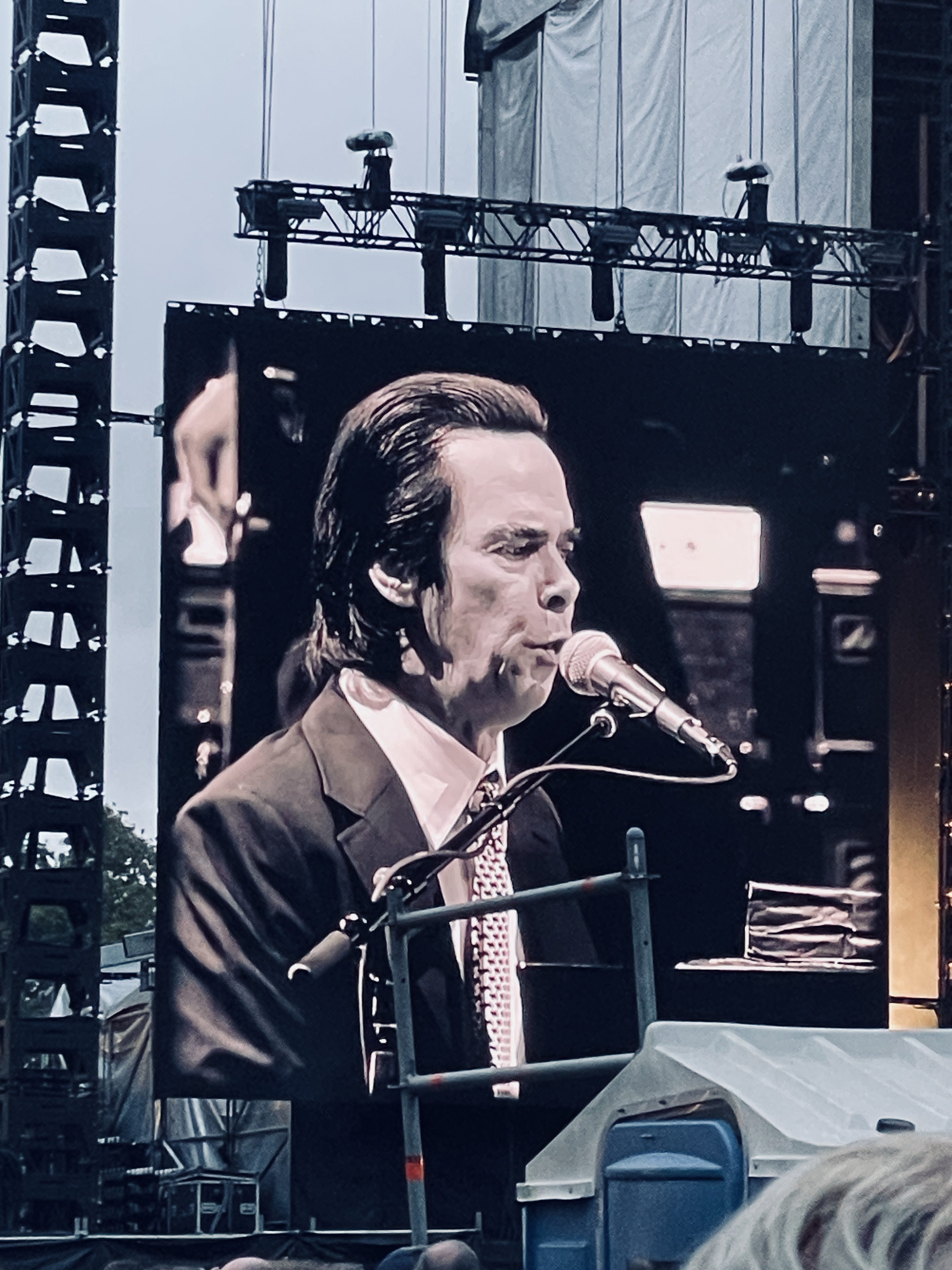 Nick Cave performing at Alexandra Gardens Melbourne. This image is of the screen by the stage