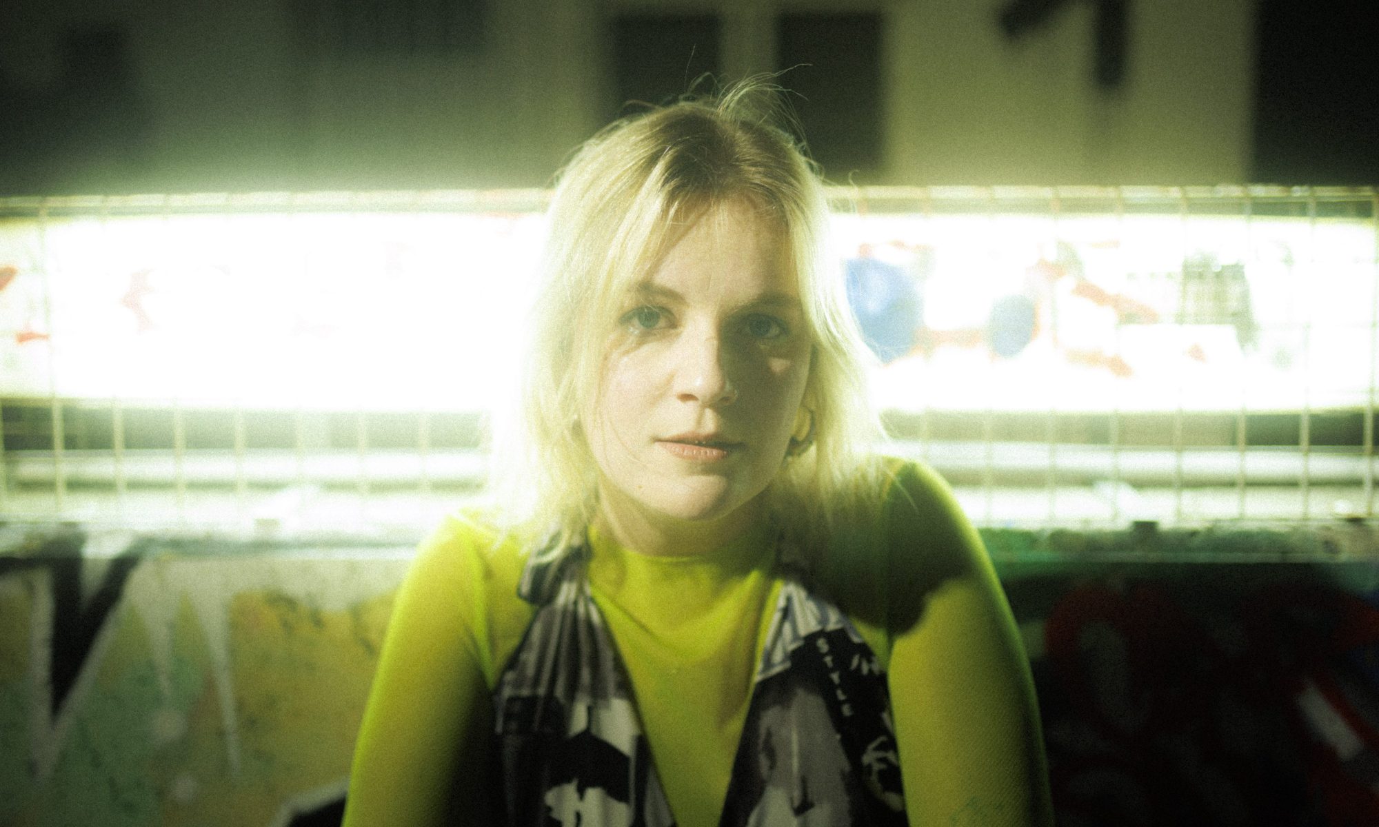 Image of singer Romanie against a strip of light in the background