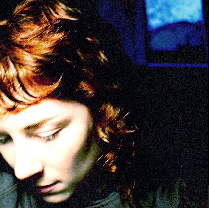 Close up of singer Lucky's face. She is looking down.