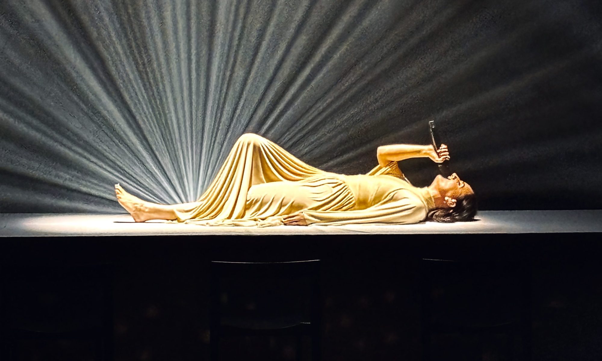 Meg Mac laying on a table while performing at Melbourne's Malthouse Theatre