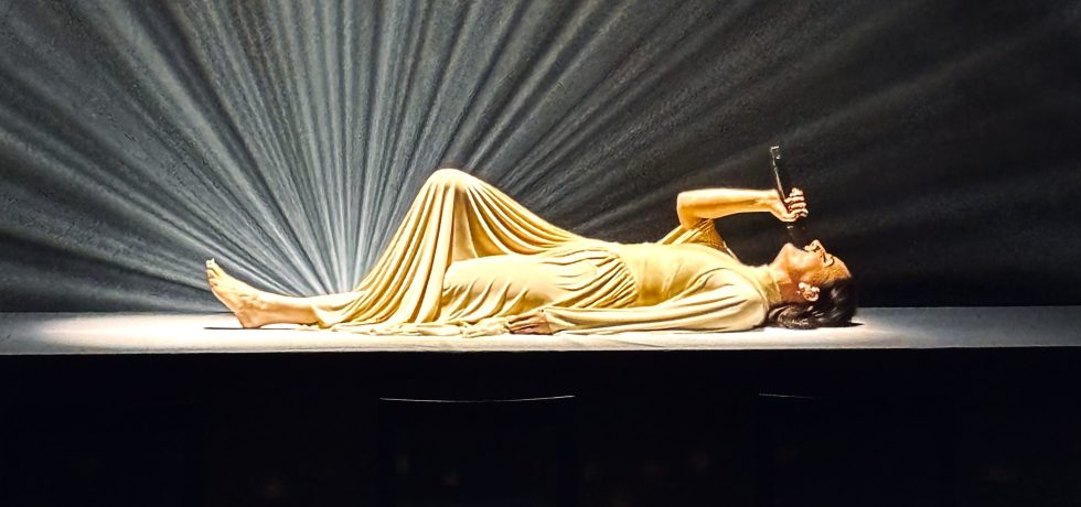 Meg Mac laying on a table while performing at Melbourne's Malthouse Theatre