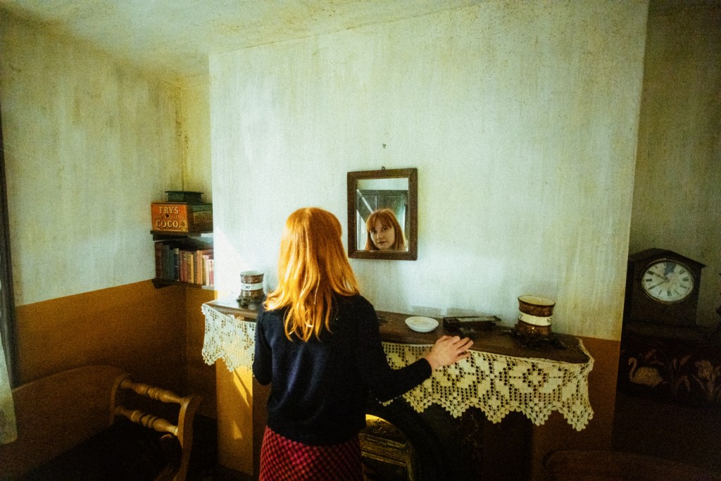 Singer Hannah Potter photographed reflected in a mirror.