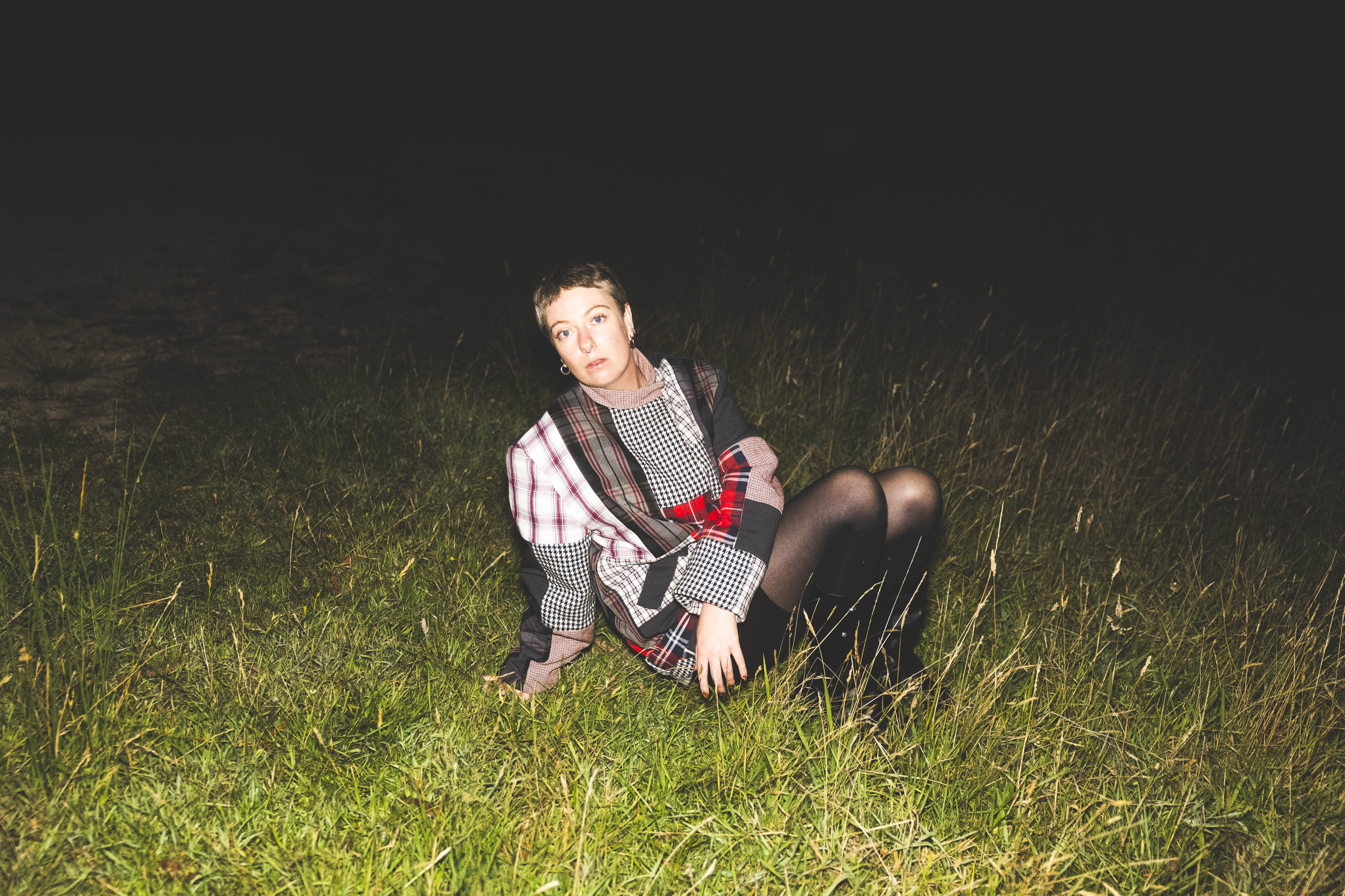 Image of singer Jannah Beth sitting on grass.