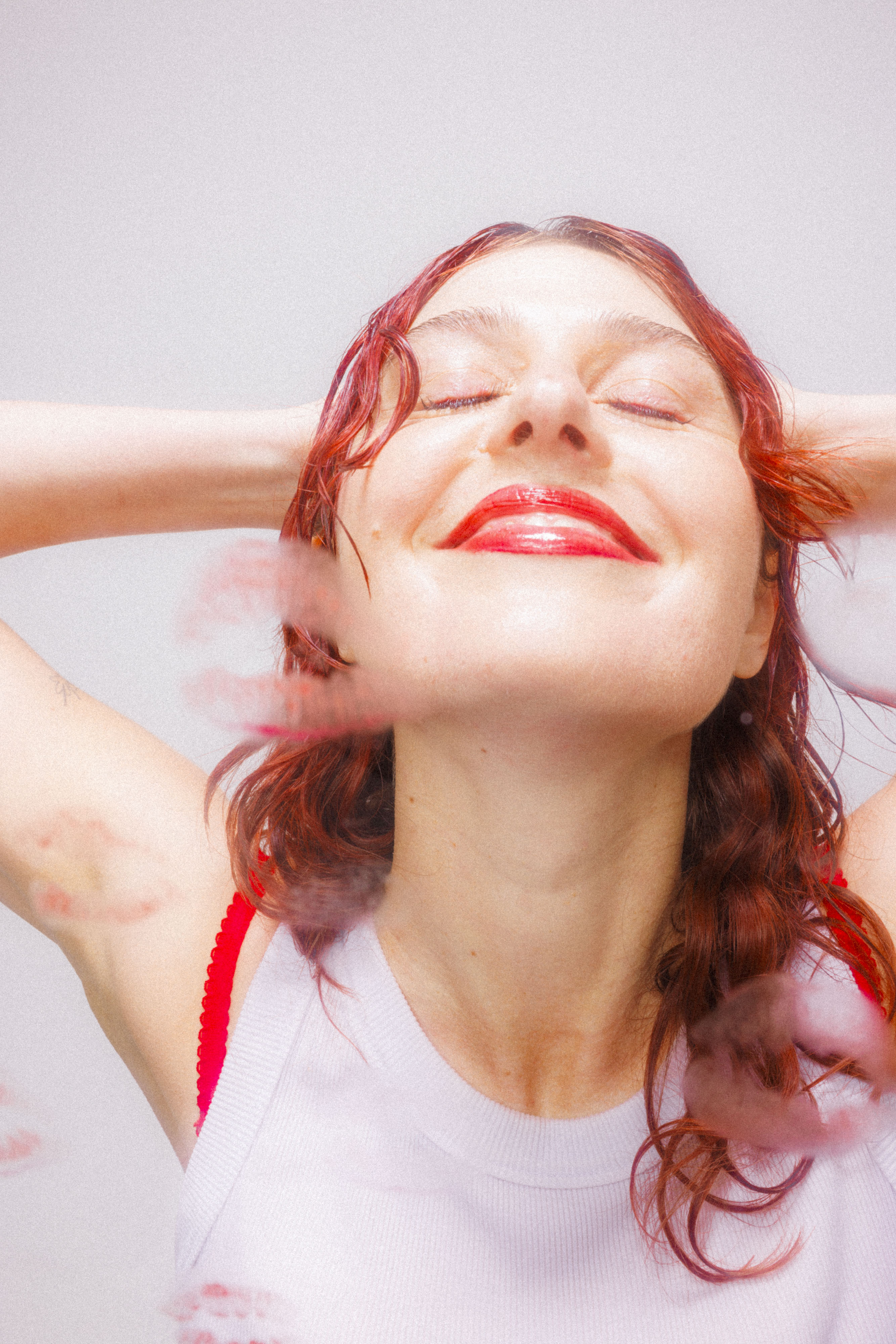 Image of Jeanie smiling with her hands behind her head