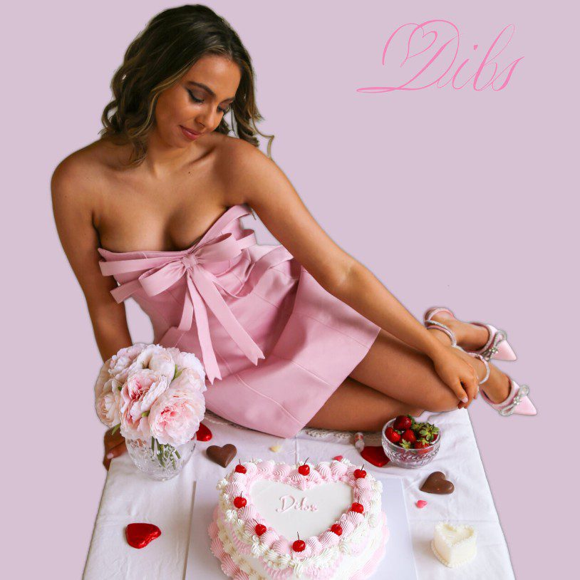 Image of singer Taylah Rose in a pink dress with a heart shaped cake and strawberries. Single cover for Dibs