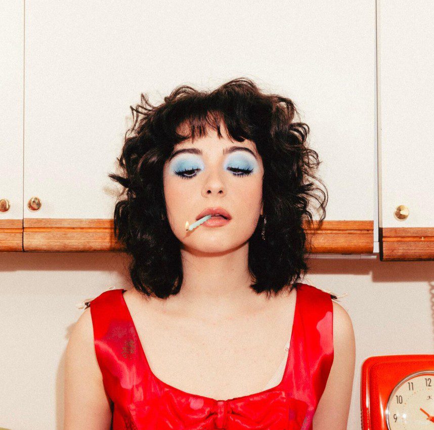 Image of Aleksiah in a red dress smoking a cigarette. EP cover for Good on Paper