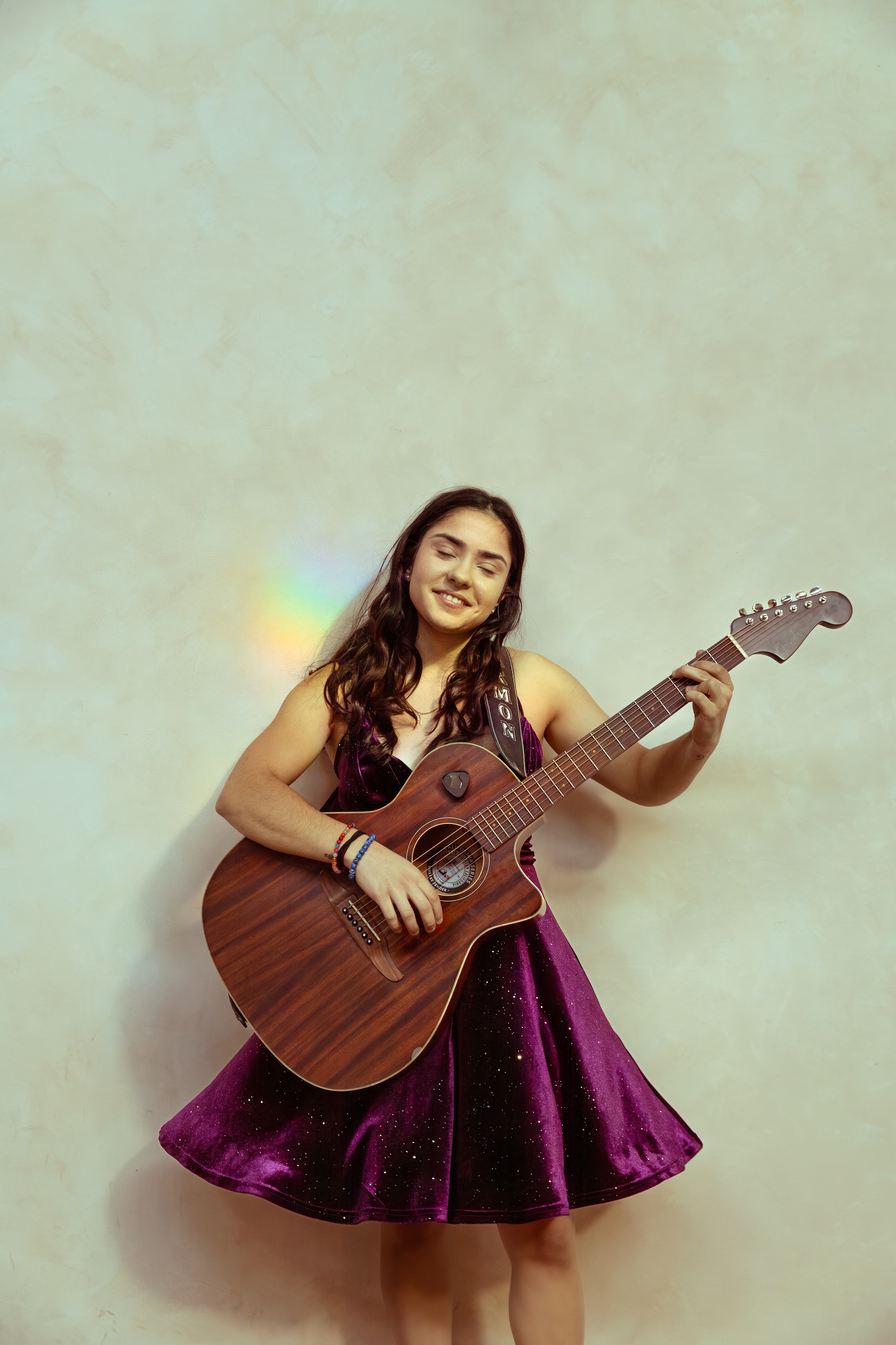 Image of Carmon in a purple dress holding a guitar. Press image for All My Life. 