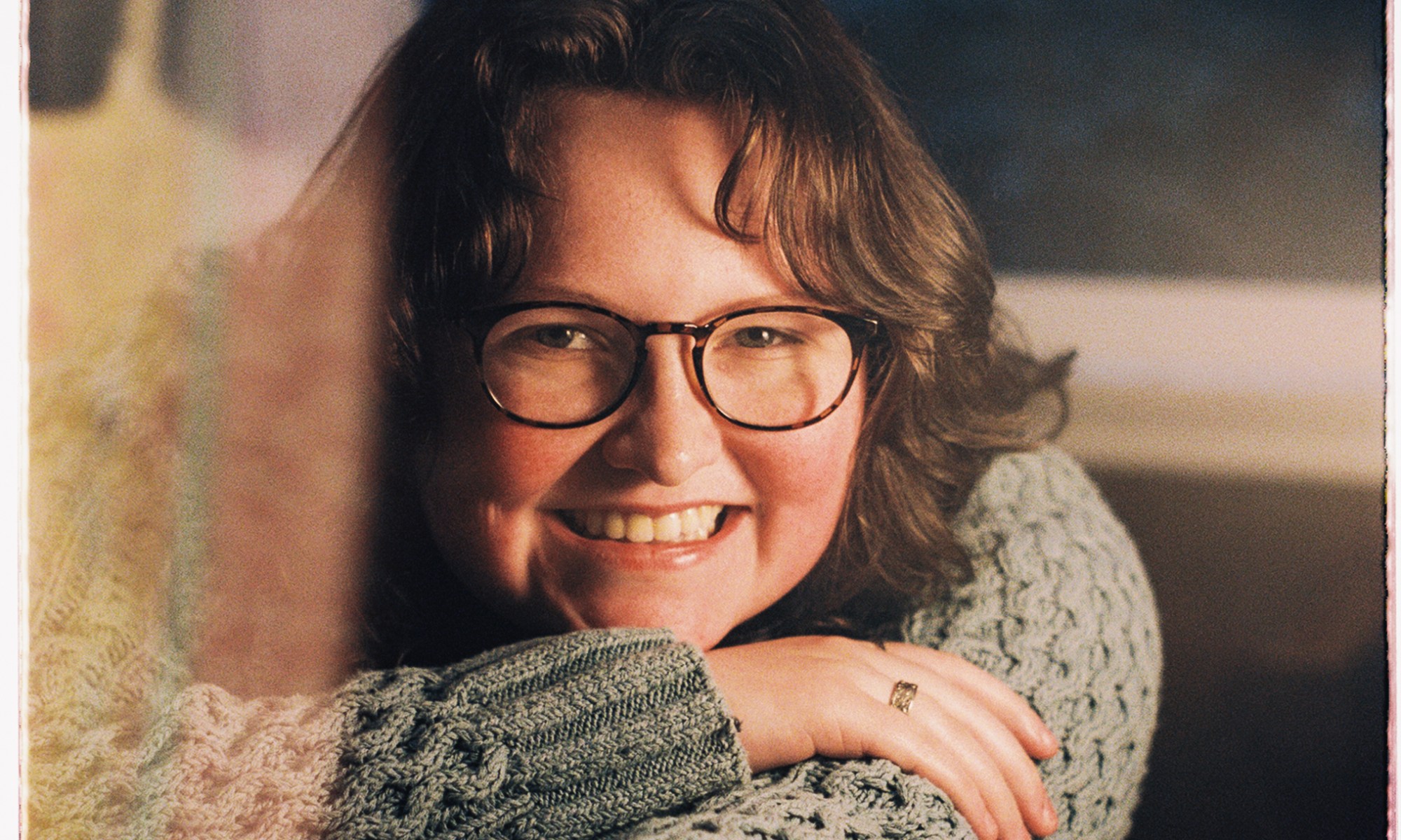 Image of Aubory Bugg leaning on a table, smiling.