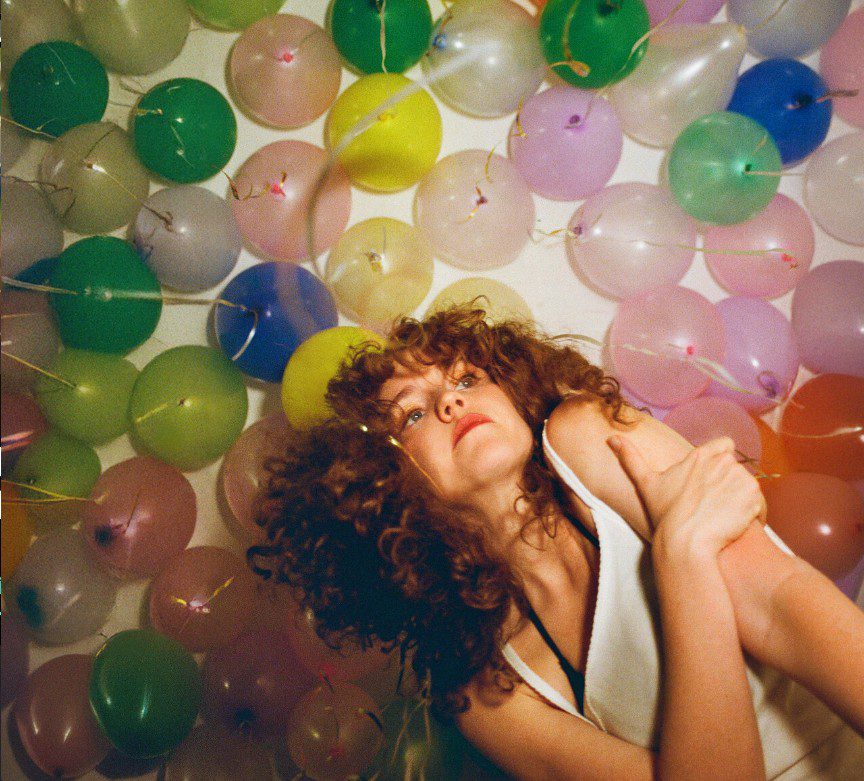 Image of singer Geowulf surrounded by balloons