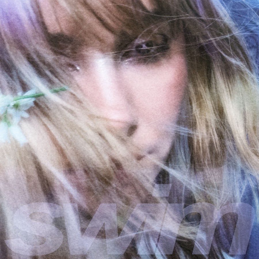 blurred close up image of woman's face with hair covering part of her face. Single Cover for Night Tapes Swim