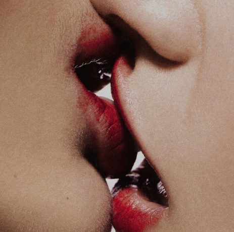 Close up of two mouths kissing both are female/femme presenting. Single cover for ENOLA Adore