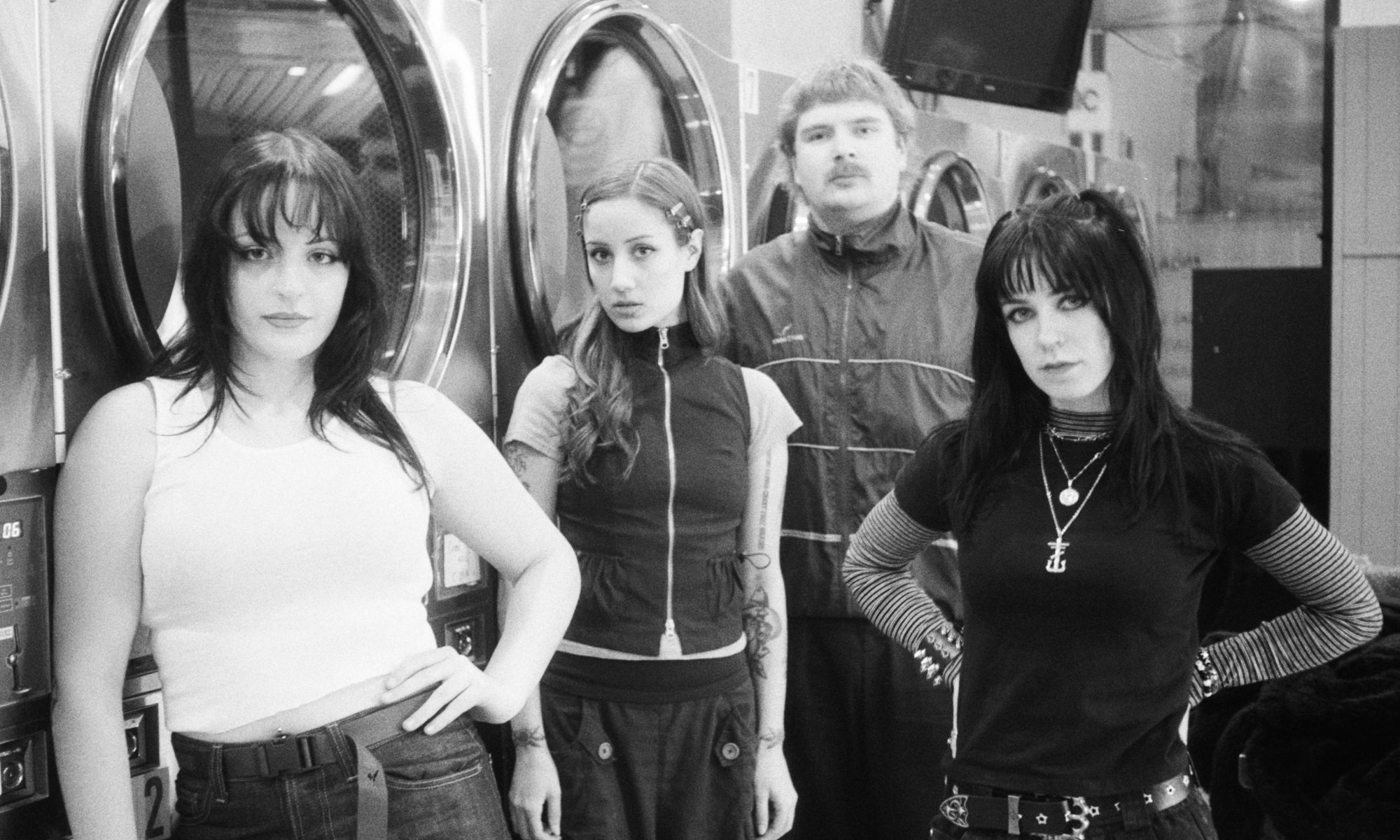 Black and white image of Laura and The Hell Cutz taken at a laundromat