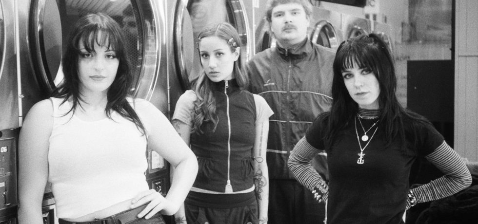 Black and white image of Laura and The Hell Cutz taken at a laundromat
