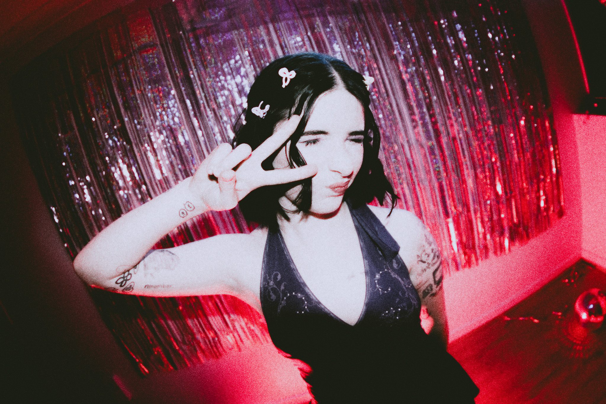 Image of Kayls against a sparkly curtain