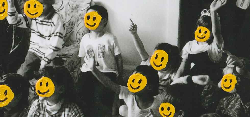 Black and white image of a group of children with their faces covered by yellow smiley faces. Single Cover for Telenova's Happy